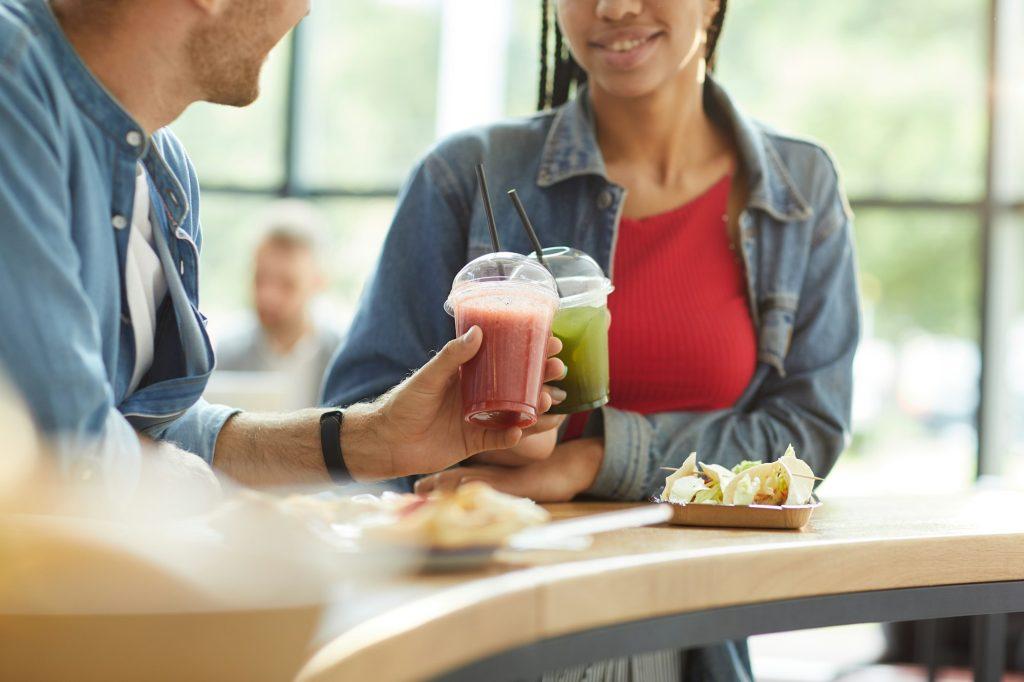 Drinking healthy smoothie in cafe